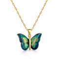 Butterfly-shaped pendant with gold chain on a white background